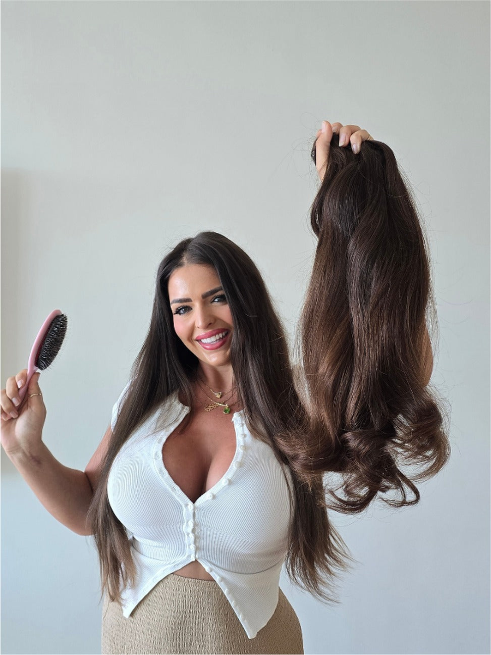 Stevi Pisoni holding a bundle of Russian virgin hair